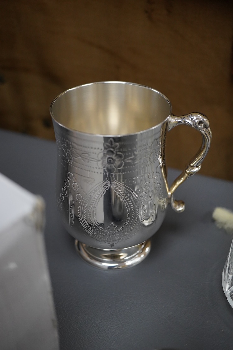 A silver plated etched cup, silver plated cup, a silver plated candlestick, two silver napkin rings, a cut glass sugar shaker and a silver paperweight & eight other items.